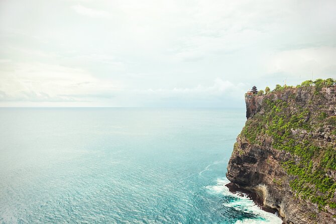 All Inclusive Private Uluwatu Tour with Kecak Dance and Dinner - Stop 1: Uluwatu Temple on the cliffs—views, carvings, and rules